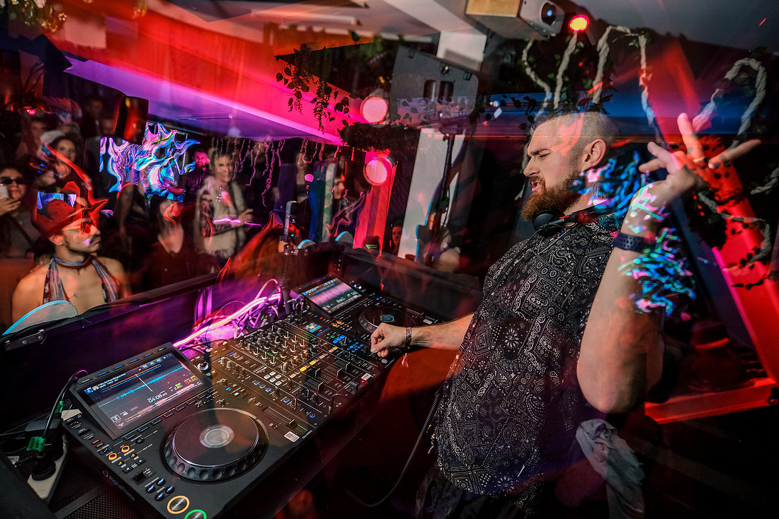 DJ performing on professional Pioneer and AlphaTheta DJ equipment at Between Realms